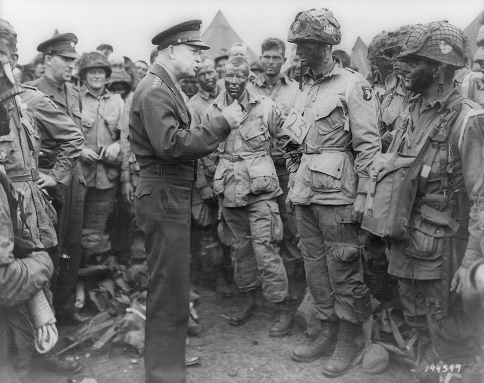 Black and white photo of General Dwight D. Eisenhower addresses American paratroopers prior to D-Day