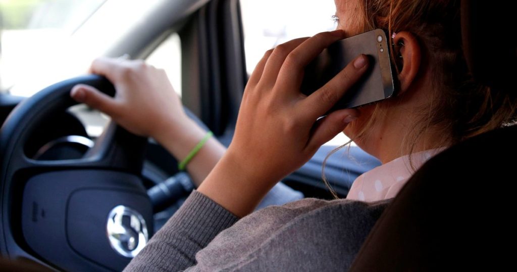 Any holding of mobile phones while driving to be banned London Globe