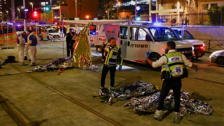 Israeli forces work at the scene of the shooting in Neve Yaakov