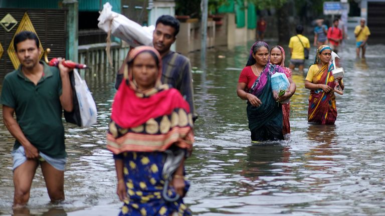 People wade through flood waters in Sylhet, Bangladesh