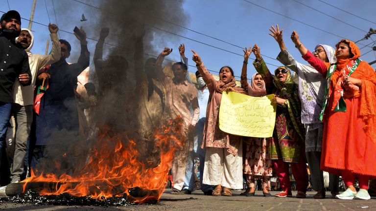 Supporters of Pakistan's former Prime Minister Imran Khan chant slogans next to burning tires during a protest to condemn the arrest of their leader, in Hyderabad, Pakistan, Tuesday, May 9, 2023. Pakistan's anti-graft agents on Tuesday arrested former Prime Minister Khan as he appeared in a court in the capital, Islamabad, to face charges in multiple graft cases, police and officials from his party said. (AP Photo/Pervez Masih)