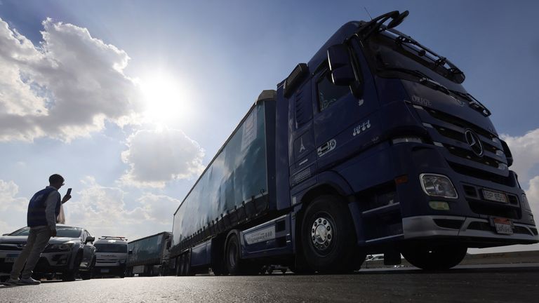 A man stands near a truck carrying humanitarian aid to Palestinians, on the desert road (Cairo - Ismailia), on the way to Rafah border crossing to enter Gaza, amid the ongoing conflict between Israel and the Palestinian Islamist group Hamas, in Cairo, Egypt, October 14, 2023. REUTERS/Amr Abdallah Dalsh